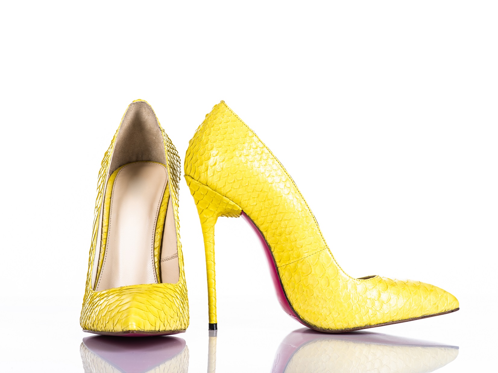 Fashionable woman's high heel shoe isolated on white background. Beautiful yellow female high heels shoe. Luxury.